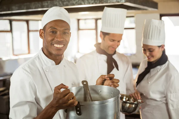 Chef sorrindo segurando panela de cozinha — Fotografia de Stock