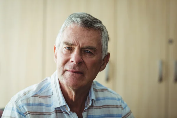 Portrait of senior man in living room — Stock Photo, Image