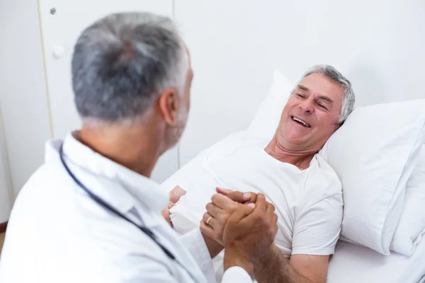 Male doctor consoling senior man — Stock Photo, Image