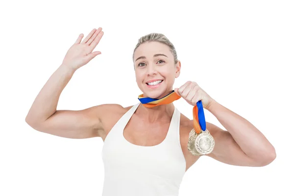Щаслива жінка-спортсменка тримає медалі — стокове фото