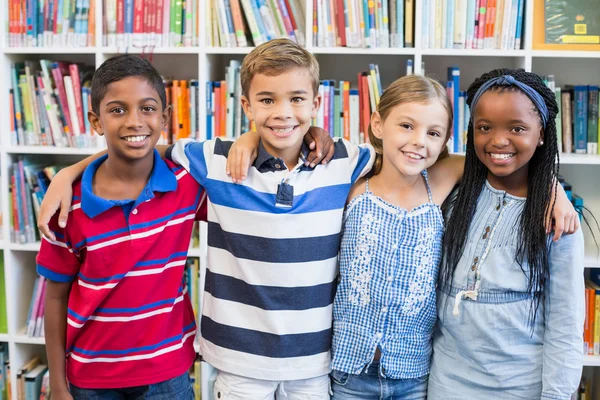 School kids standing in library — Stock Photo, Image