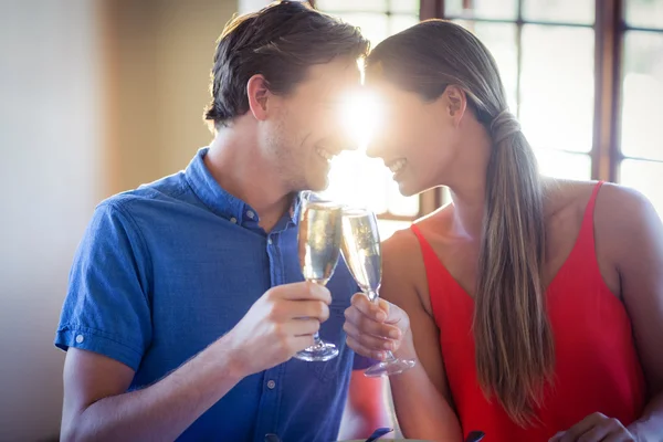 Couple looking face to face and toasting — Stock Photo, Image