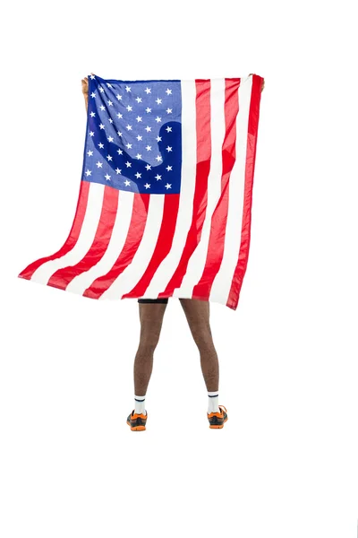 Sportovec pózuje s americkou vlajkou po vítězství — Stock fotografie