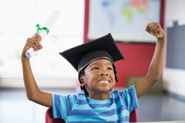 Excited schoolboy holding certificate — Stock Photo, Image