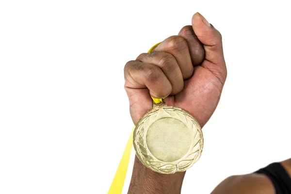 Atleta segurando medalha de ouro após a vitória — Fotografia de Stock