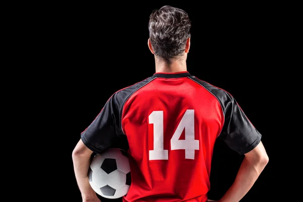 Zadní pohled sportovec drží fotbal — Stock fotografie