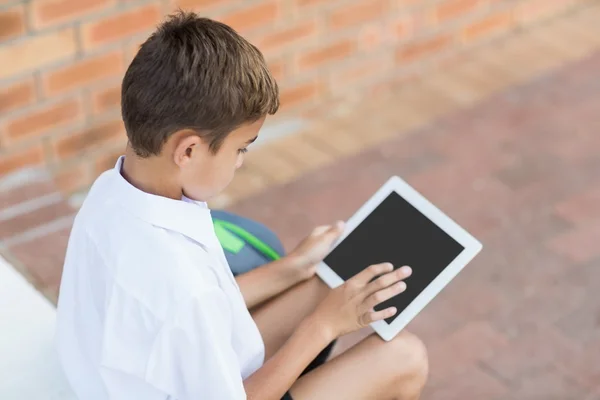 Schoolboy in corridor using tablet — Stock Photo, Image