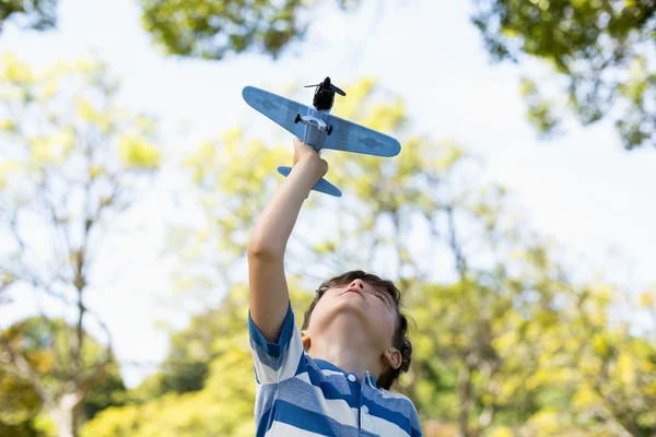 Ragazzo che gioca con un aeroplano giocattolo — Foto Stock