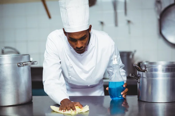 Chef cleaning kitchen counter — Stock Photo, Image