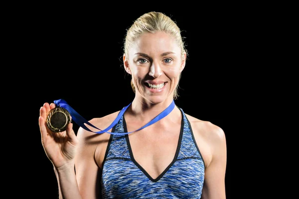 Female athlete posing with gold medal around his neck — Stock Photo, Image