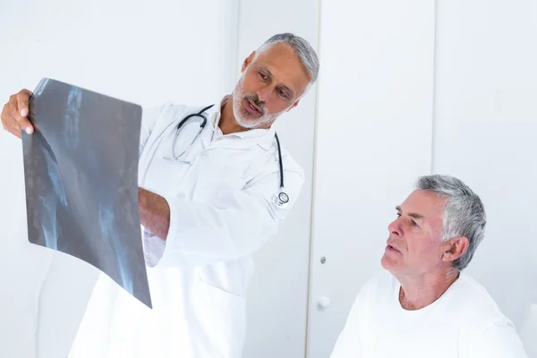 Male doctor discussing x-ray with senior man — Stock Photo, Image
