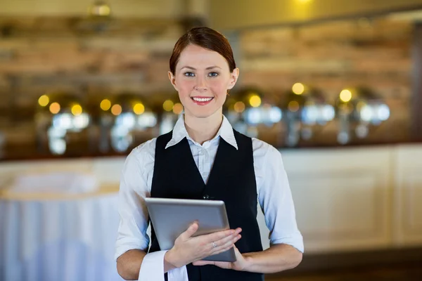 Smiling waitress holding tablet Stock Picture