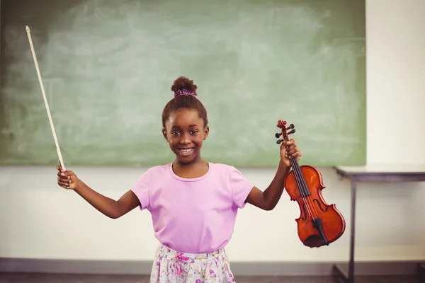 Smiling schoolgirl holding violin — Stock Photo, Image