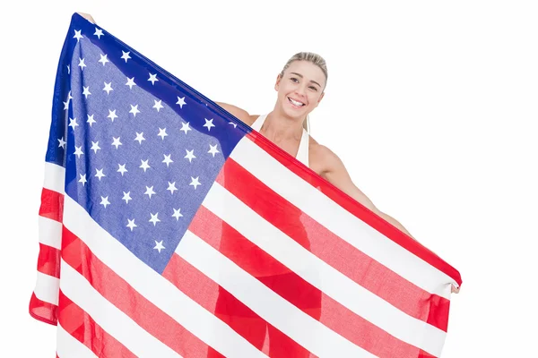 Female athlete holding American flag — Stock Photo, Image