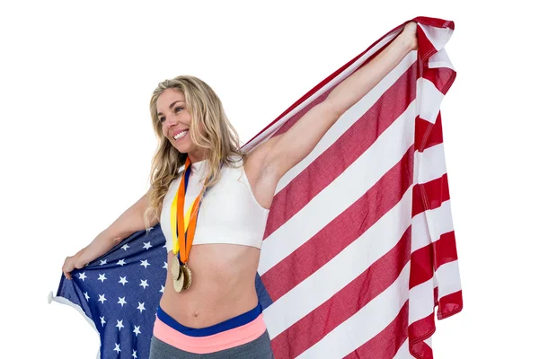 Спортсмен позирует с американским флагом после победы — стоковое фото
