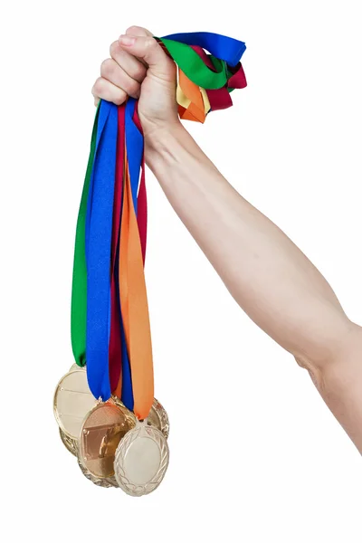 Närbild på en hand som håller medaljer — Stockfoto