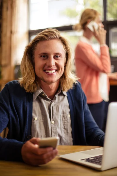 Hipster using laptop and smartphone — Stock Photo, Image