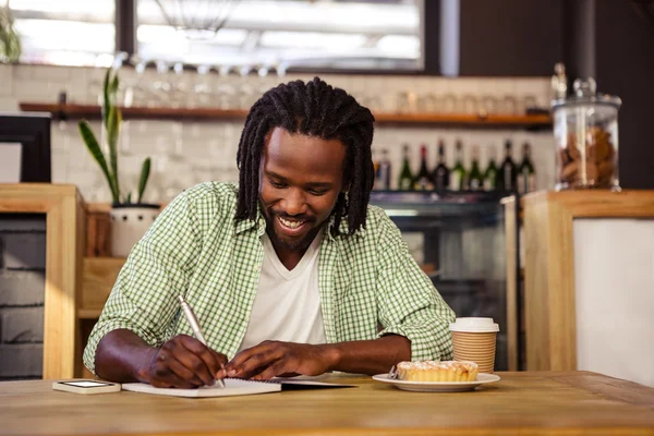 Hombre escribiendo en un cuaderno — Foto de Stock