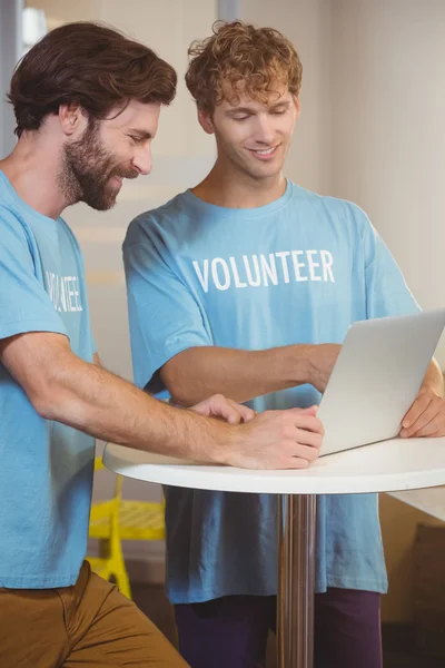 Voluntarios usando un portátil — Foto de Stock