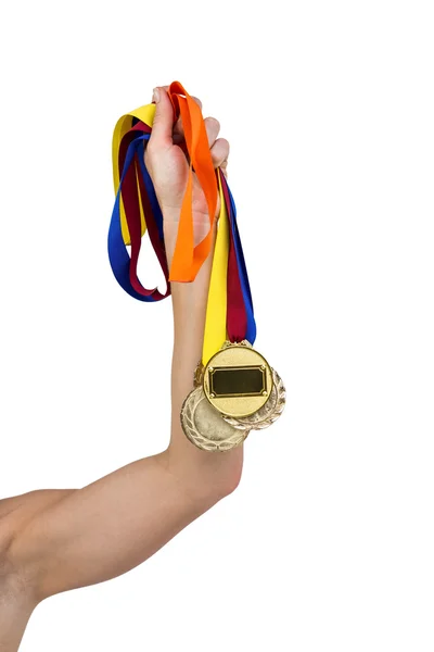 Athlete holding gold medals after victory — Stock Photo, Image