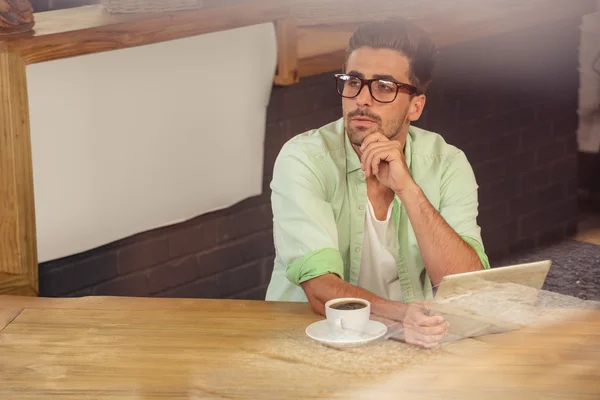 Thoughtful hipster using tablet — Stock Photo, Image