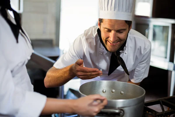 Head chef smelling the food — Stock Photo, Image