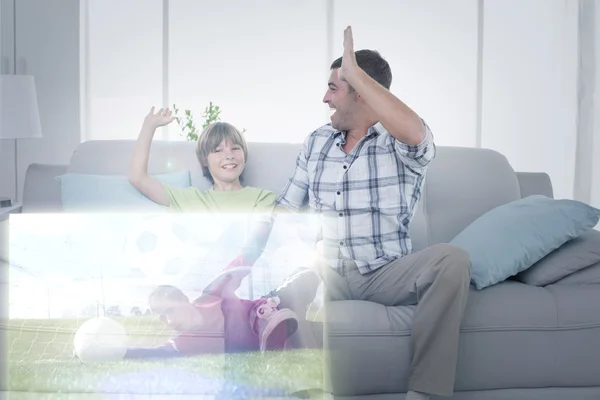 Father and son in front of soccer match — Stock Photo, Image