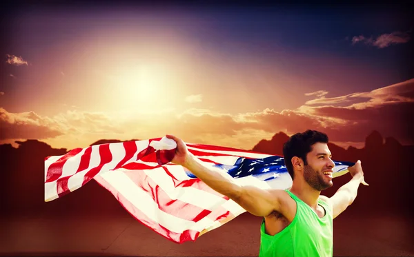 Desportista segurando bandeira americana — Fotografia de Stock