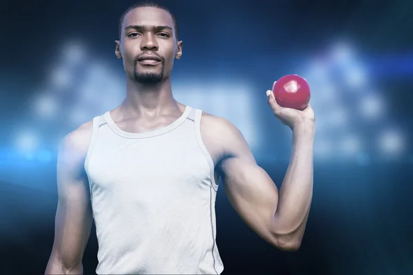 Serious sportsman holding shot put — Stock Photo, Image