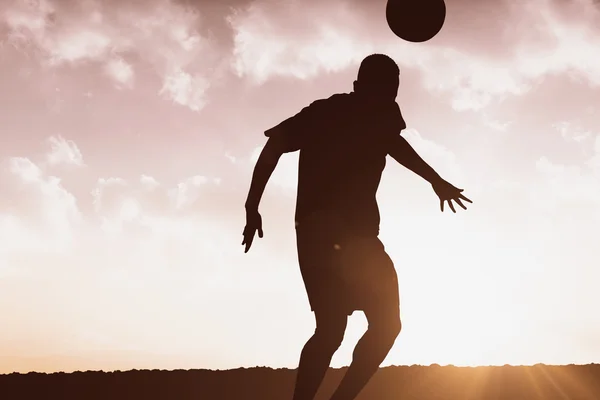 Football player hitting header — Stock Photo, Image