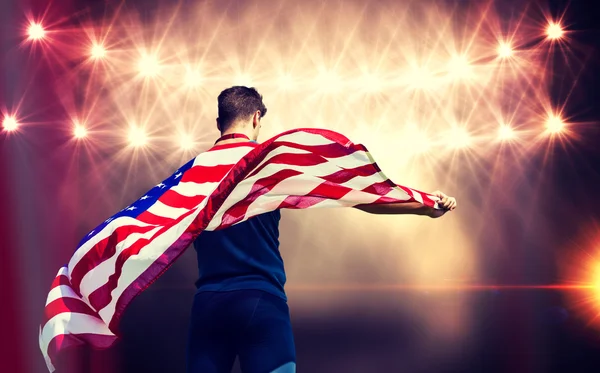 Deportista sosteniendo bandera americana — Foto de Stock