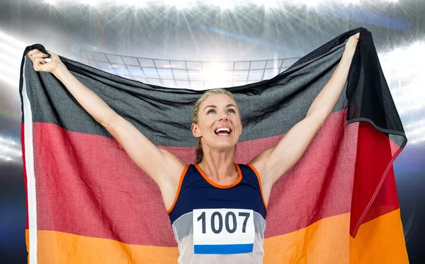 Atleta posando con bandera alemana después de la victoria — Foto de Stock