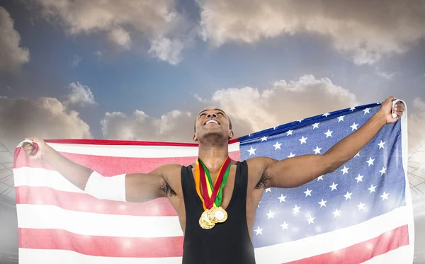Athlete holding gold medals and american flag — Stock Photo, Image