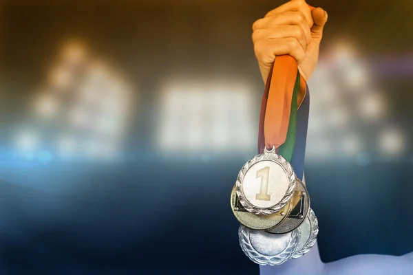 Athlete holding gold medals after victory — Stock Photo, Image