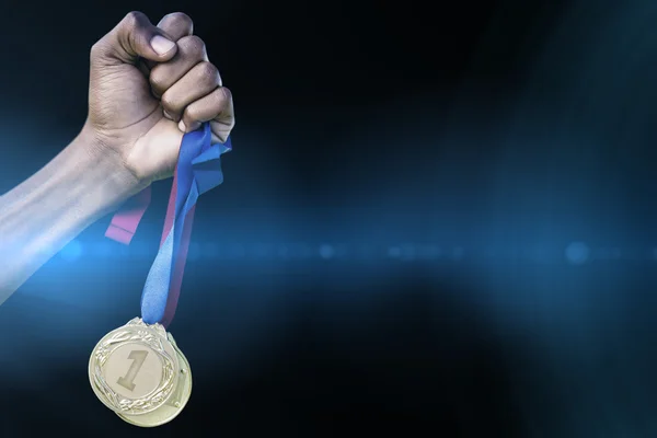Hand holding two gold medals — Stock Photo, Image