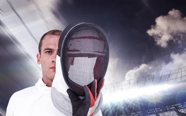 Swordsman holding fencing mask — Stock Photo, Image