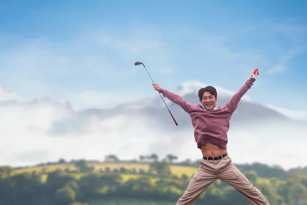 Man jumping with golf club — Stock Photo, Image