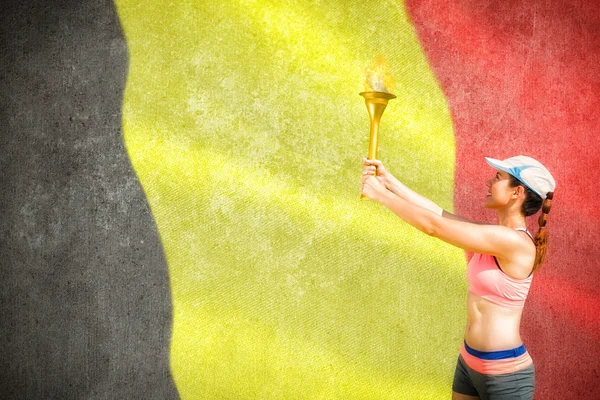 Sporty woman holding olympic torch — Stock Photo, Image