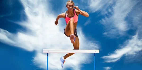 Athletic woman practicing show jumping — Stock Photo, Image