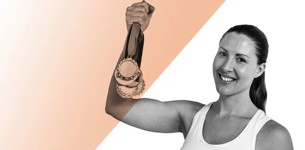 Female athlete posing with gold medals — Stock Photo, Image