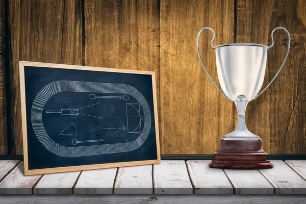 Trophy against wooden table — Stock Photo, Image