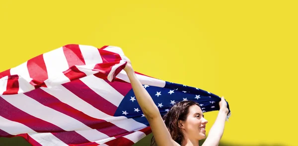 Sportswoman raising american flag — Stock Photo, Image