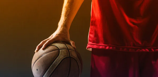 Basketball held by basketball player — Stock Photo, Image