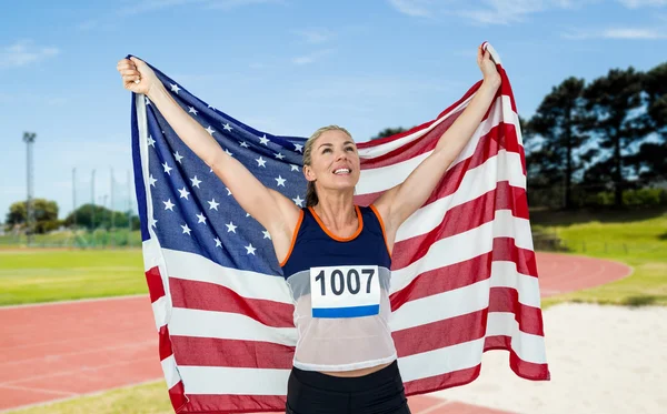 Atleta in posa con bandiera americana — Foto Stock