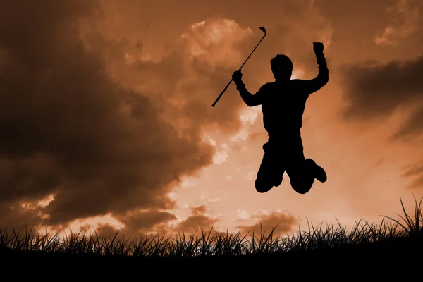Man jumping with golf club — Stock Photo, Image