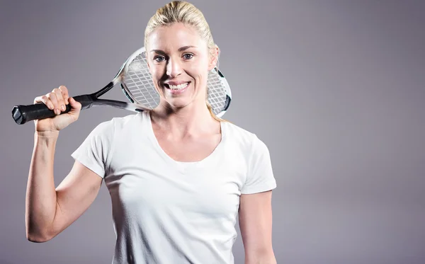 Female tennis player posing with racket — Stock Photo, Image