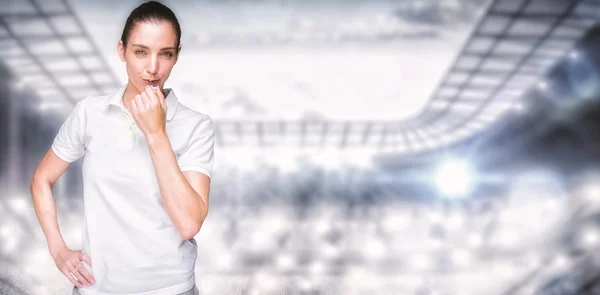 Female athlete blowing a whistle — Stock Photo, Image