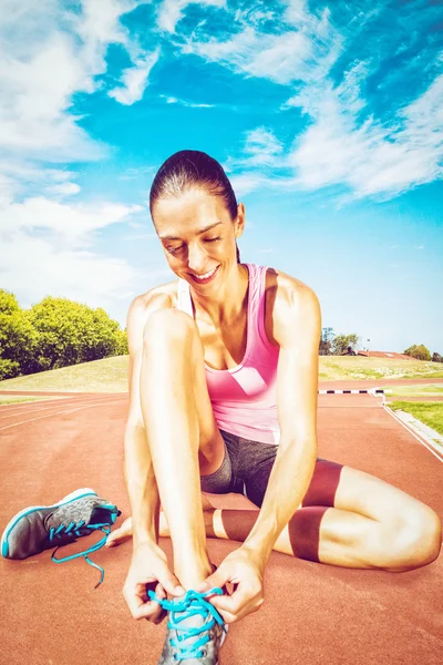 Sporty woman doing her shoelace — Stock Photo, Image