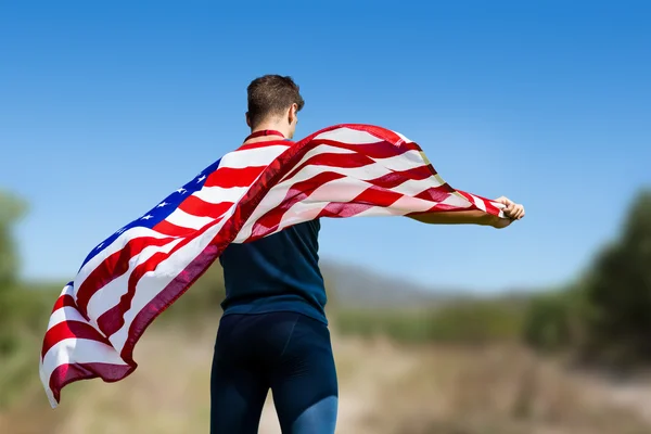 Bir Amerikan bayrağı tutarak sporcu — Stok fotoğraf