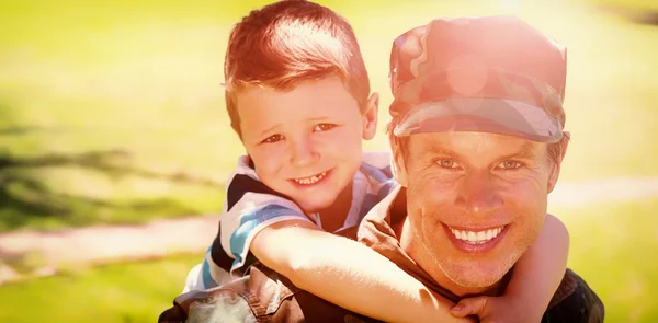 Soldier giving piggyback to his son — Stock Photo, Image